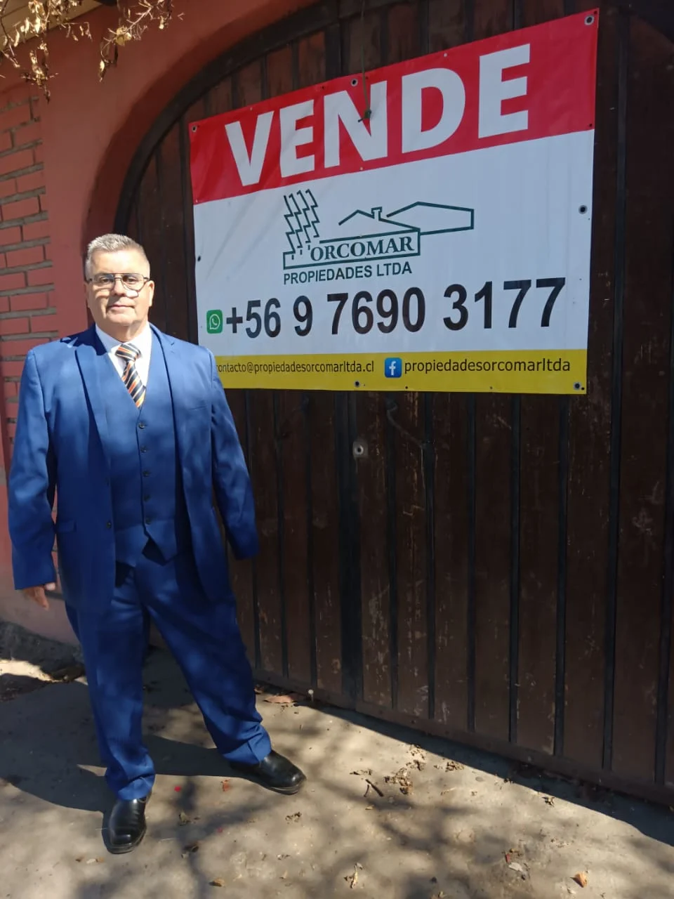 Don Mario Arturo Rivas Hernández, corredor de propiedades, junto a un letrero de venta de ORCOMAR